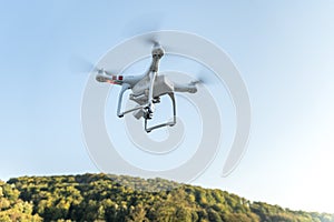 Drone with digital camera flying in the sky