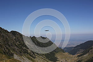 Drone DJI Mavic Pro hovers in the air at tre Romania mountains, Transfagarasan mountain road photo