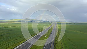 Drone, earth and traffic driving on road outdoor in countryside for vacation, adventure or journey. Landscape, sky and