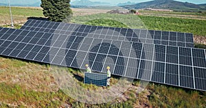 Drone, engineering or people with solar panels outdoor for renewable energy, clean electricity or sustainability. Aerial