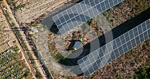 Drone, engineering or people with solar panels outdoor for renewable energy, clean electricity or sustainability. Aerial