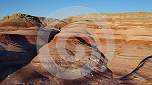 Drone flies low over moonscape red rocks in Utah, USA