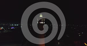 A drone flies at night around the tower of an ancient complex Kalyan Minaret.