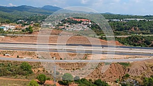 the drone flies over the field towards the high-speed highway.