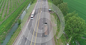 A drone flies over a truck driving on the highway.