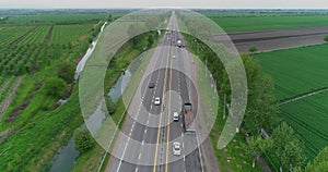 A drone flies over a truck driving on the highway.