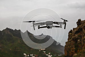 Drone flies and taking photos and videos in the mountains.