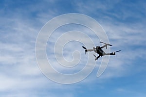 Drone in Flight Against Cloudy Sky