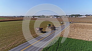 Drone Flight over Agricultural Fields and Wheat Fields being Harvested by Amish Farmer and Horses