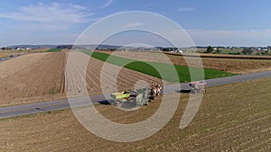 Drone Flight over Agricultural Fields and Wheat Fields being Harvested by Amish Farmer and Horses