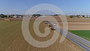 Drone Flight over Agricultural Fields and Wheat Fields being Harvested by Amish Farmer and Horses