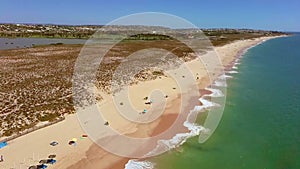 Drone flight over empty Gale beach in Portugal with top view on shoreline