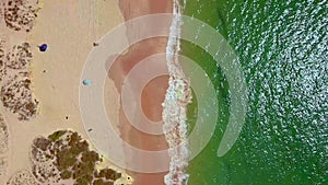 Drone flight over empty Gale beach in Portugal with top view on shoreline