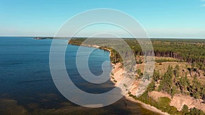 Drone flight over the Kiev reservoir, overlooking the steep coast and the forest