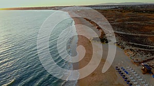 Drone flight over shore line on empty Gale beach in Portugal