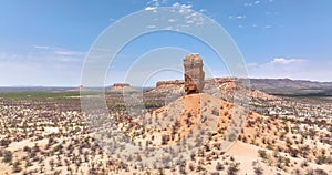 Drone flight towards the famous Vingerklip rock needle in northern Namibia during the day