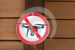 Drone flights prohibited sign on wooden wall background