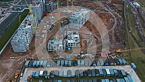 Drone fly above town of red and blue prefabricated lodges for construction workers and watchmen