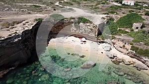 Drone fly over a sandy beach with blue sea