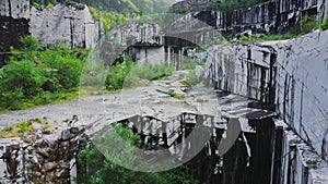 Drone fly up inside abandoned white marble quarry in Carrara, Italy.