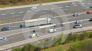 DRONE: Flying above a cargo truck carrying heavy freight through a traffic jam.