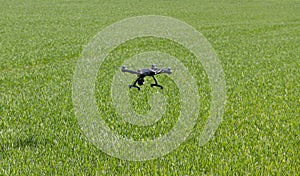 Drone flying above field.