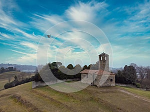 Drone flying above a little red church in the countryside