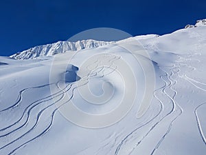 DRONE: Flying above snowboarding and ski tracks left in the deep powder snow.