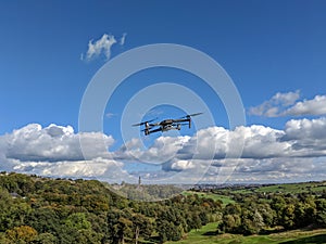 Drone flying against blue sky