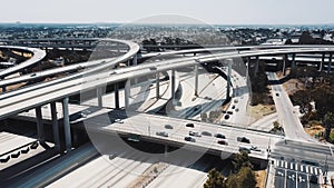 Drone flying around majestic Judge Pregerson highway road interchange in Los Angeles, USA with cars on multiple levels.