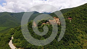 Drone flying away from old Nekresi monastery, view of Alazani valley in Georgia