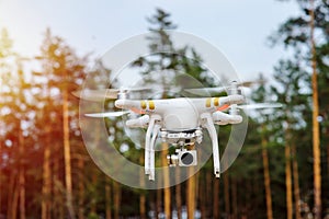 Drone flying on a background of forest trees