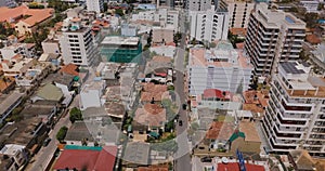 Drone flying backwards over the town of Colombo, Sri Lanka. Aerial view of Asian cityscape with modern and old buildings