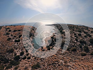 Drone flying between  the bays from turquoise water and waves