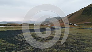 Drone flying close to the grounds, over Icelandic landscape with black sand on the ground