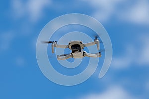 Drone flying in fromt of a blue sky