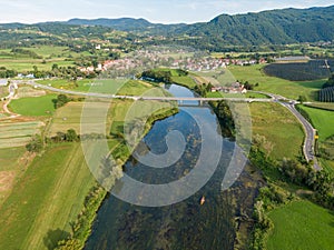 DRONE: Flying high above a group of friends paddling a canoe down river Krka