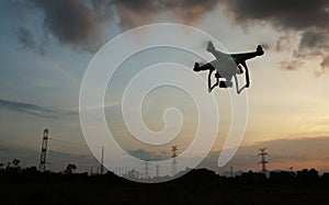 Drone flying near electricity power lines tower