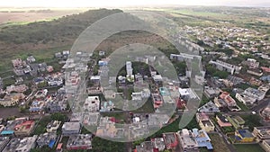 Drone flying over the Belle Etoile town in Mauritius, close to Port Louis. Stormy Sky and mountain in Background