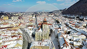 Drone flying over Brasov, Romania - Black Church and downtown, winter travel landmark in Carpathian Mountains, Transylvania