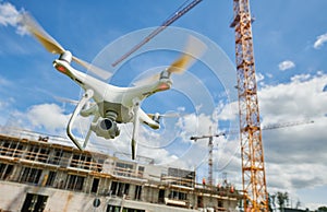 Drone flying over construction site. video surveillance or industrial safety inspection