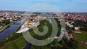 Drone flying over fair Dult in Regensburg, Bavaria, Germany with ferris wheel and beer tentson sunny day