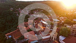 Drone flying over the green hills and beautiful buildings in Sighnaghi at sunset