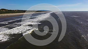 Drone flying over kite boarder in Pacific Ocean in Oregon