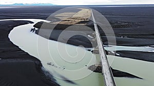 Drone flying over long bridge on frozen river landscape