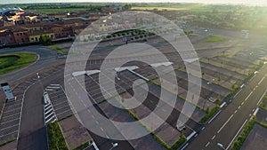 Drone flying over parking, checking free places at outlet village Mantova, Italy