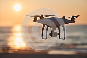 Drone flying over an sea at sunset