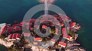 Drone flying over the Sveti Stefan island and Adriatic coast. Sveti Stefan, Montenegro. Famous travel destination