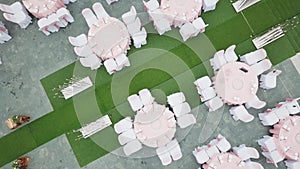 Drone flying over wedding dinner decoration, or marriage anniversary, in the garden outdoor, catering setting chairs and