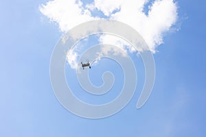 Drone flying in the sky with a mounted digital camera used for photographing and quadcopter on sky background